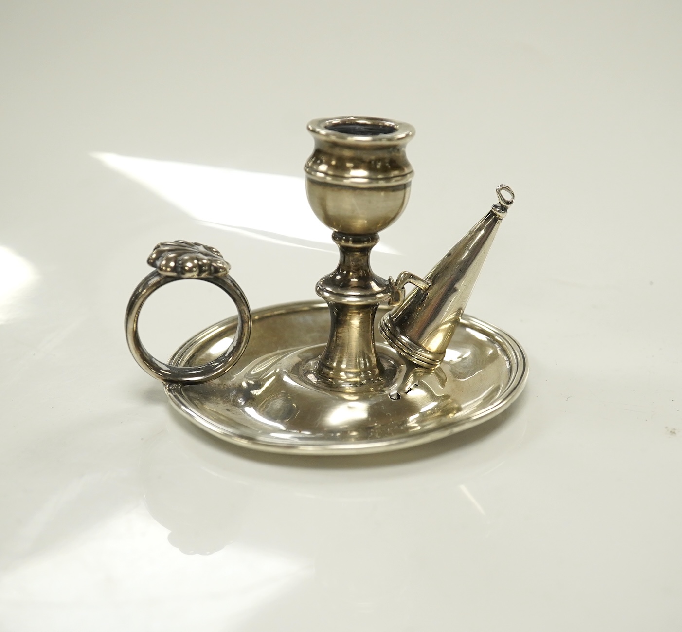 A George III miniature silver chamber stick, Emes & Barnard, London, 1815(a.f.), with matching snuffer, base diameter 75mm. Condition - poor